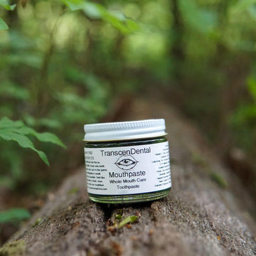 charcoal toothpaste on a log. natural toothpaste in nature where it belongs. baking soda toothpaste in a natural setting.