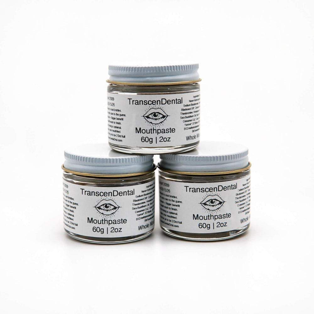 Three stacked 60g jars of TranscenDental nano-hydroxyapatite toothpaste