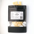 GingerCinnaMint xylitol mints spilling from an Ora Flora pouch