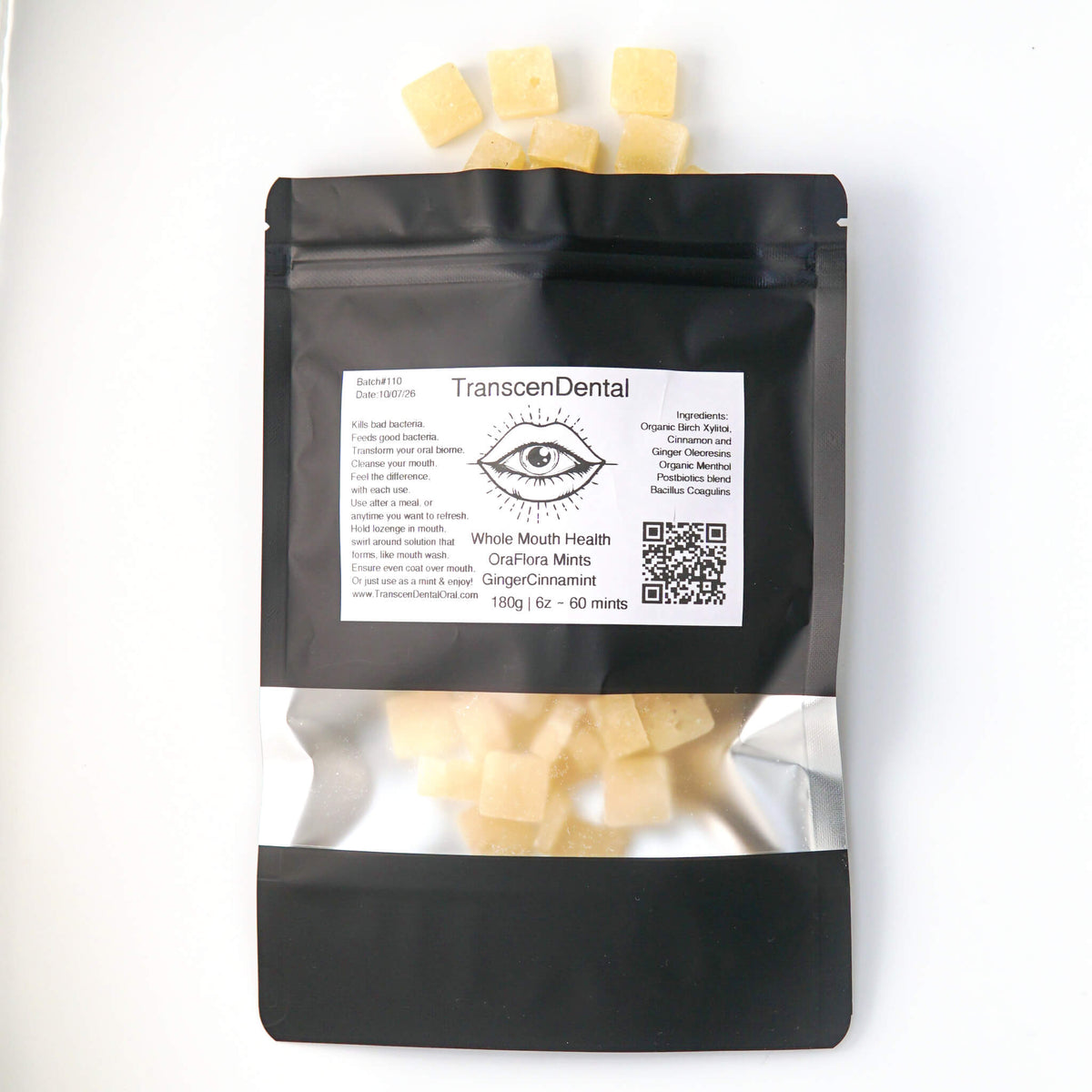 GingerCinnaMint xylitol mints spilling from an Ora Flora pouch