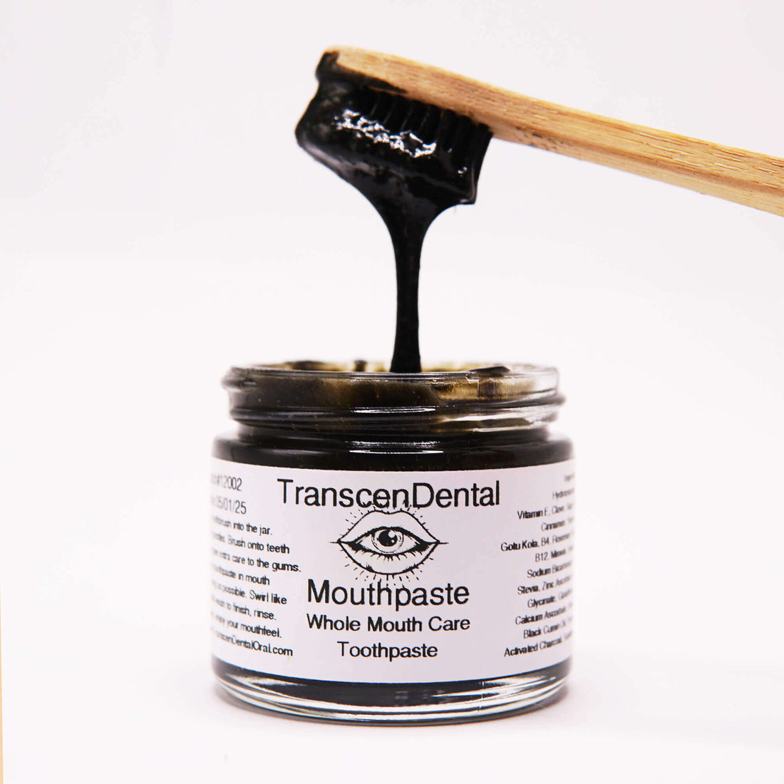 charcoal toothpaste drips off charcoal brush with baking soda and organic xylitol