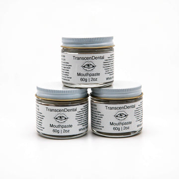 Three stacked 60g jars of TranscenDental nano-hydroxyapatite toothpaste